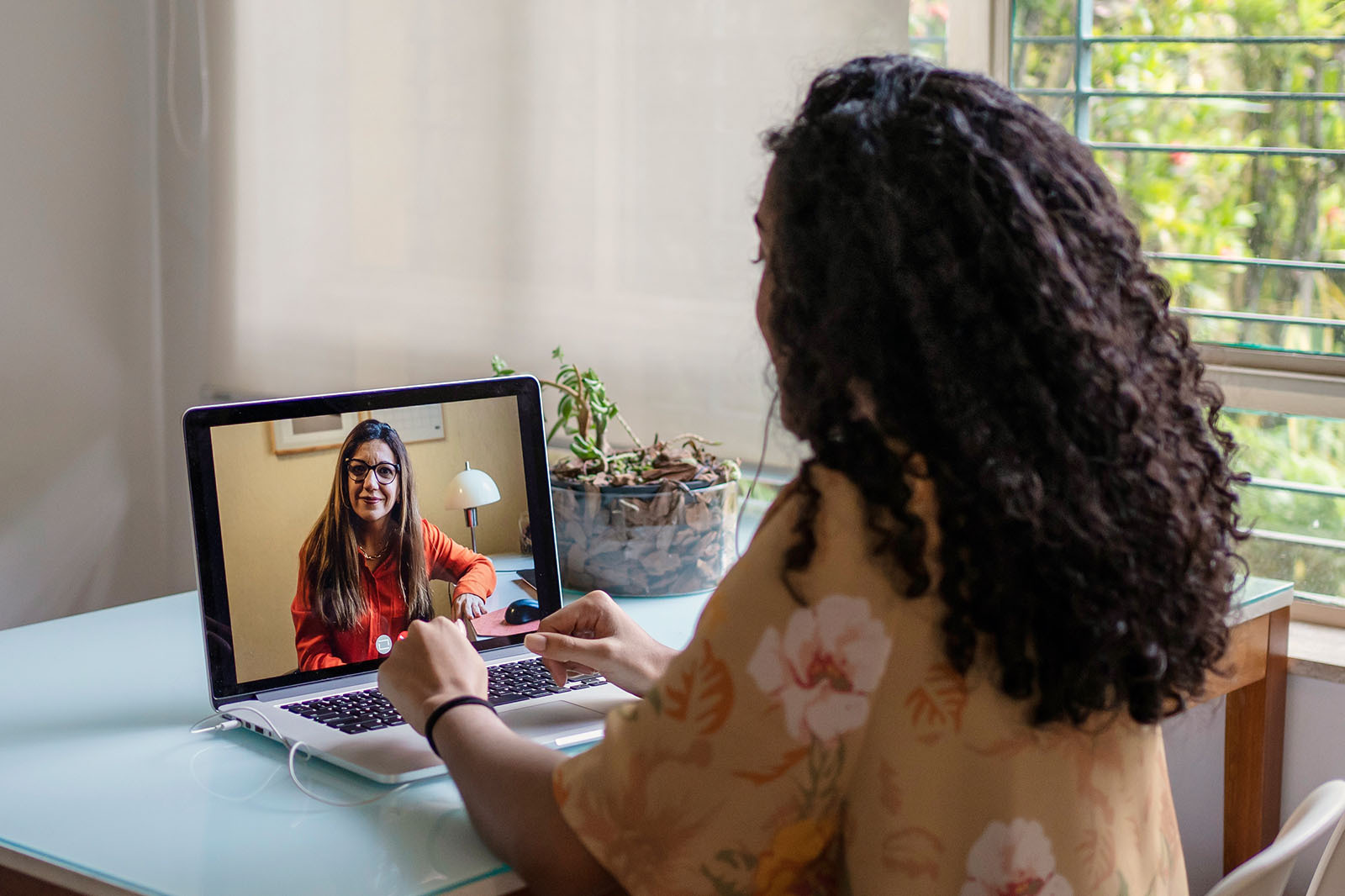 A woman speaks with a mental health provider through Modern Health