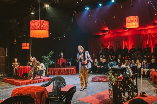 Svetozar Cvetković (Aegisthus), an older white man, is on stage, being watched by other performers