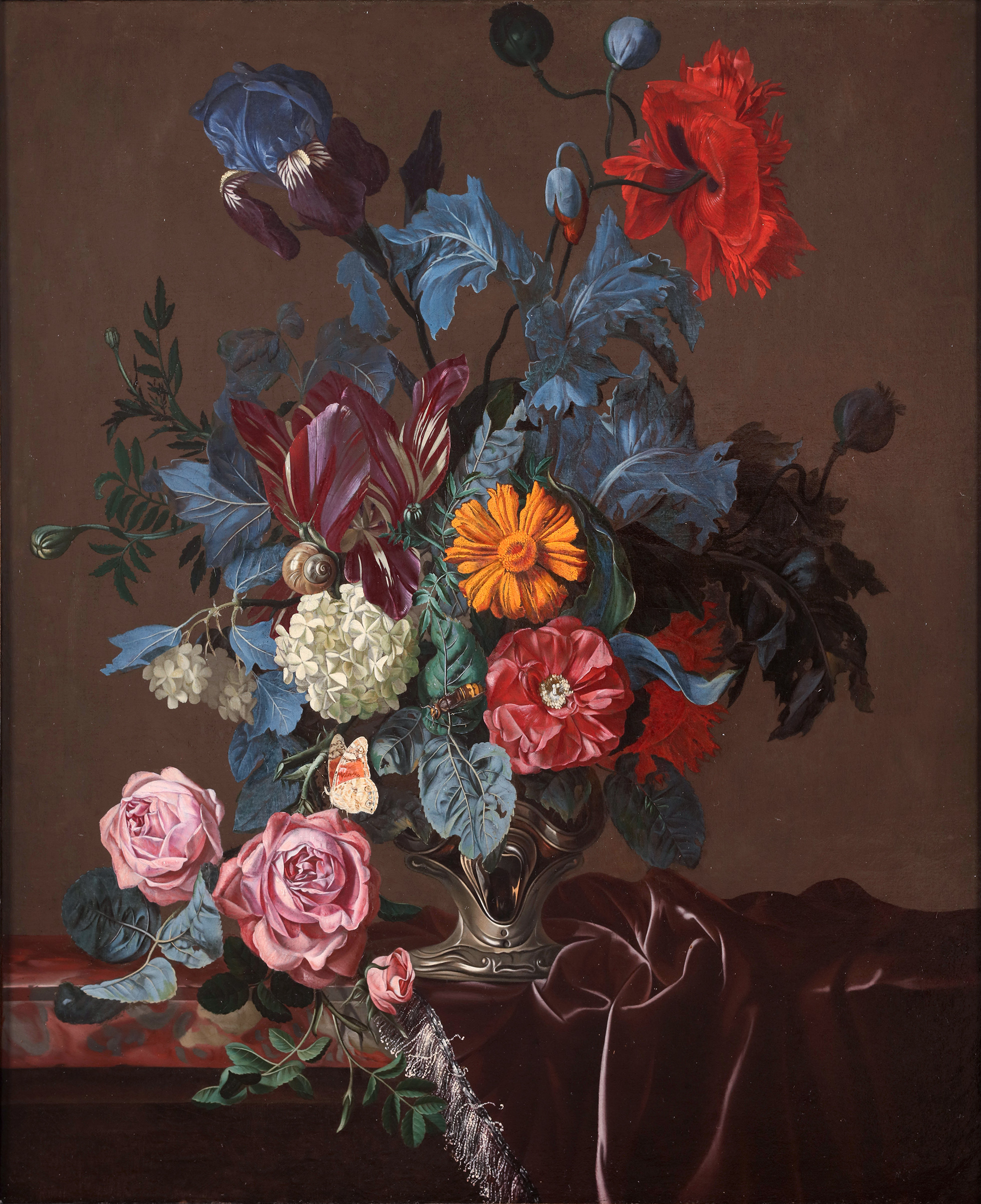 Flowers in a silver vase on a marble ledge