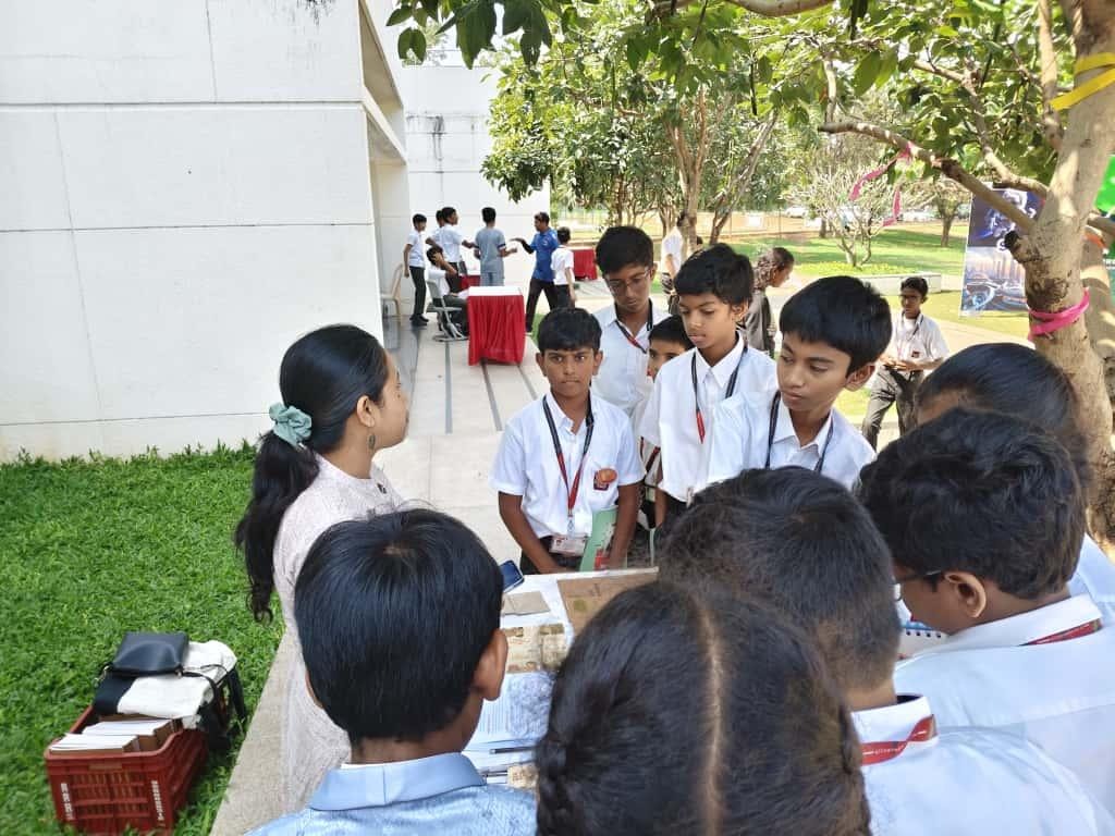 A group of children standing around a tableAI-generated content may be incorrect.