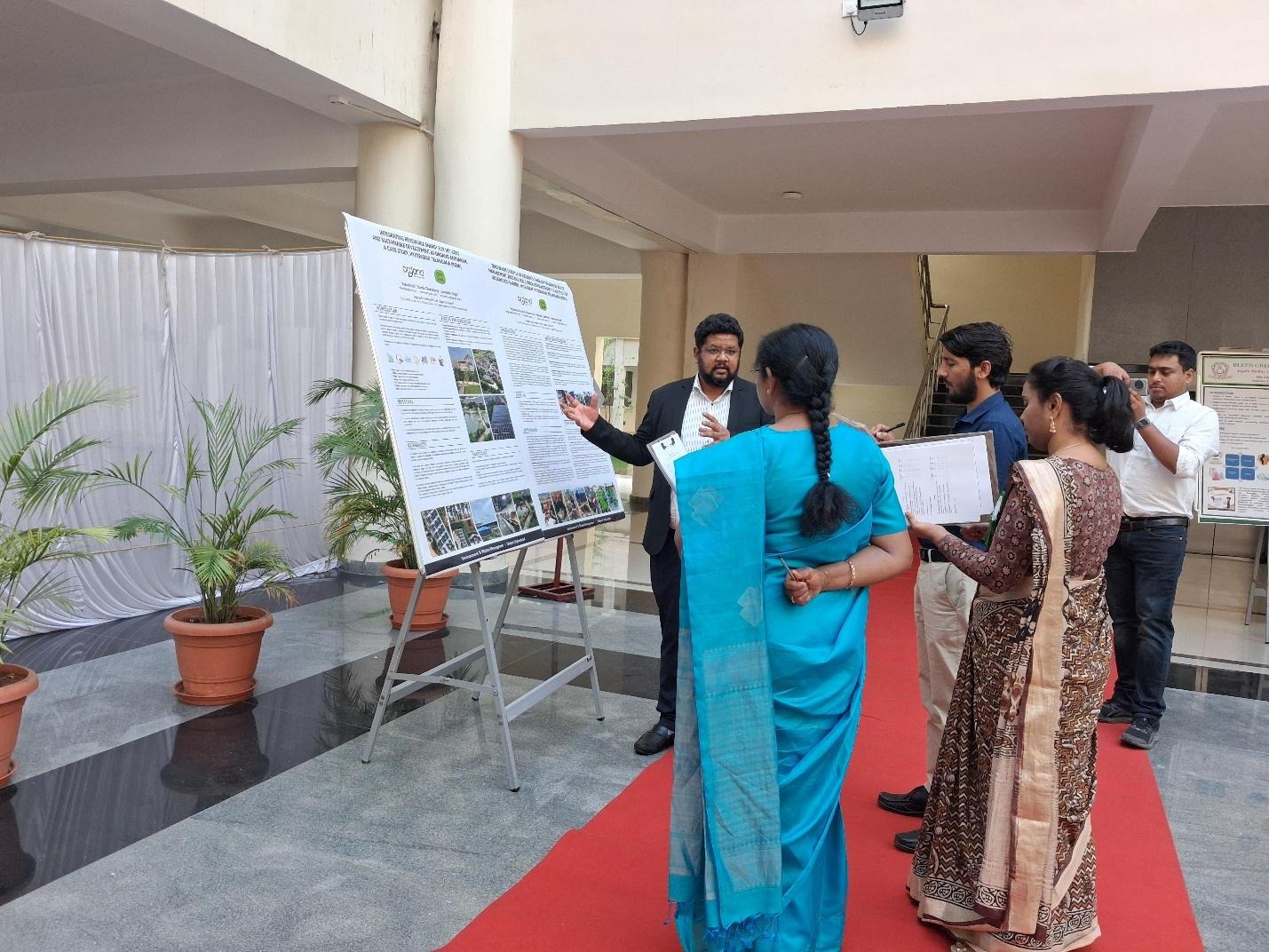 A group of people standing in front of a white boardAI-generated content may be incorrect.