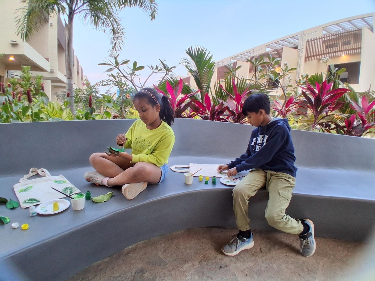 A couple of children sitting on a benchAI-generated content may be incorrect.