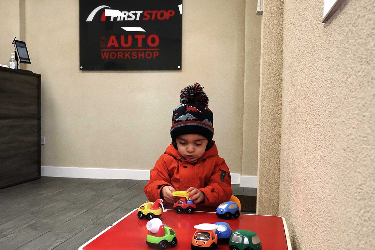a small boy playing with yoys in the reception area