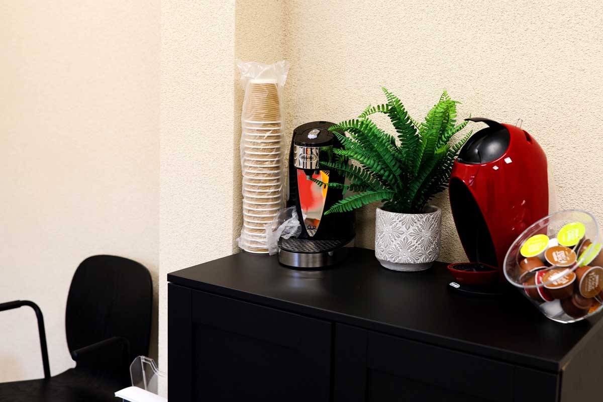 a coffee machine and cups in the reception area