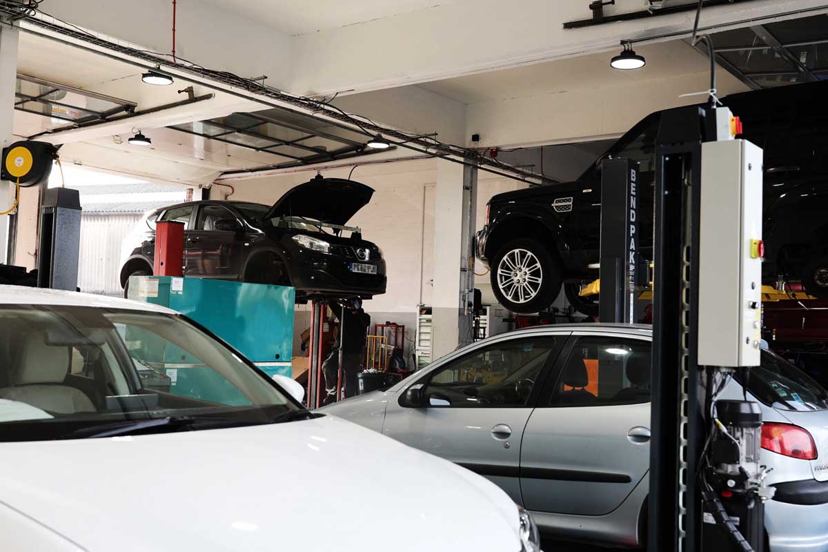 various cars being mended in the garage