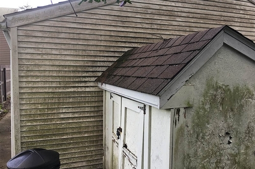 Pressure washing the exterior of a house