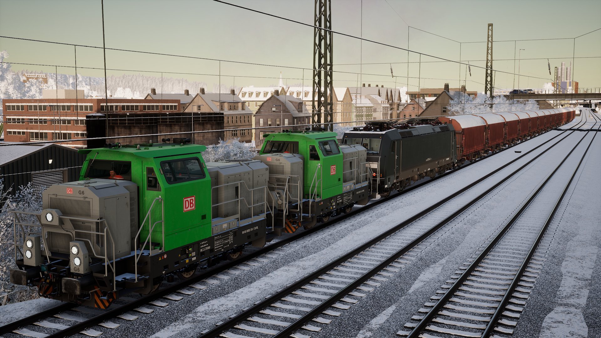 Two G6 shunters pull a broken-down locomotive and its train in snowy weather