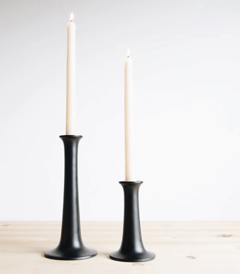 3 lit candles , with a sign saying "Thankful