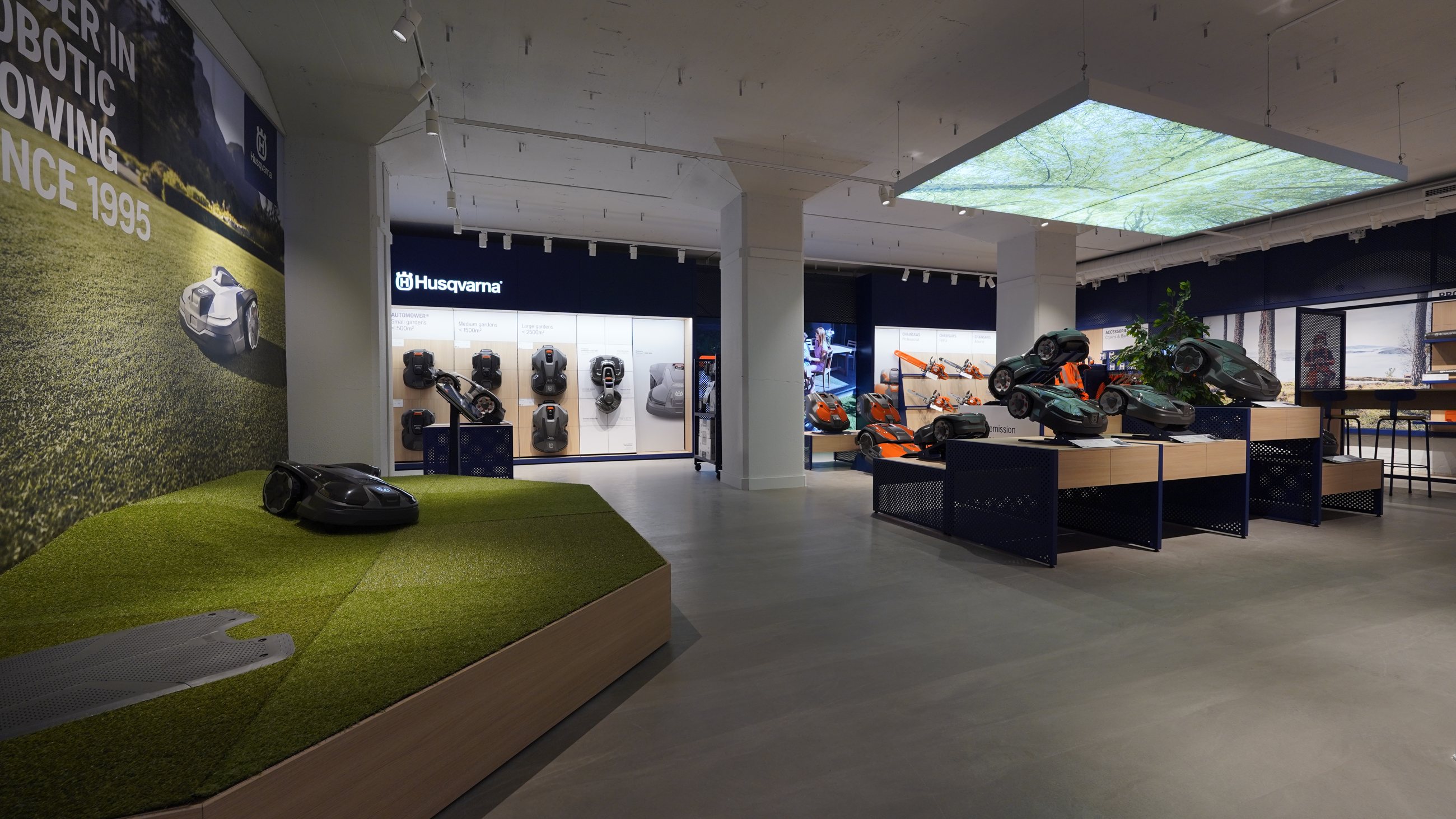Wide view of the Husqvarna pilot store with turf demonstration area and product displays