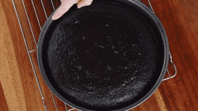 Robyn points out the slight gap that appears along the edge of the pan when a gluten-free cake has finished baking