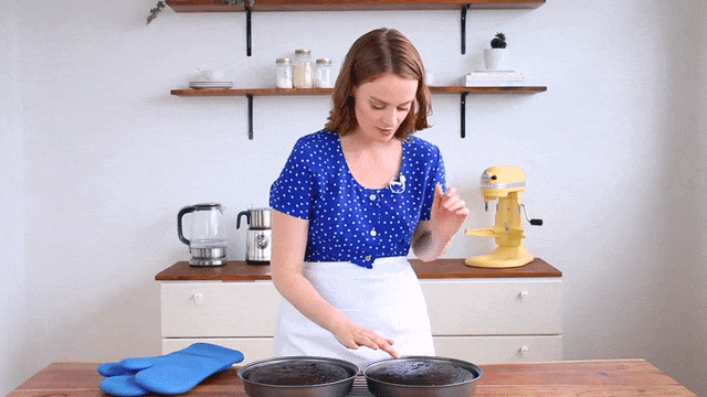 Robyn gently taps the top centre of the gluten-free chocolate cake to check that it is has finished baking