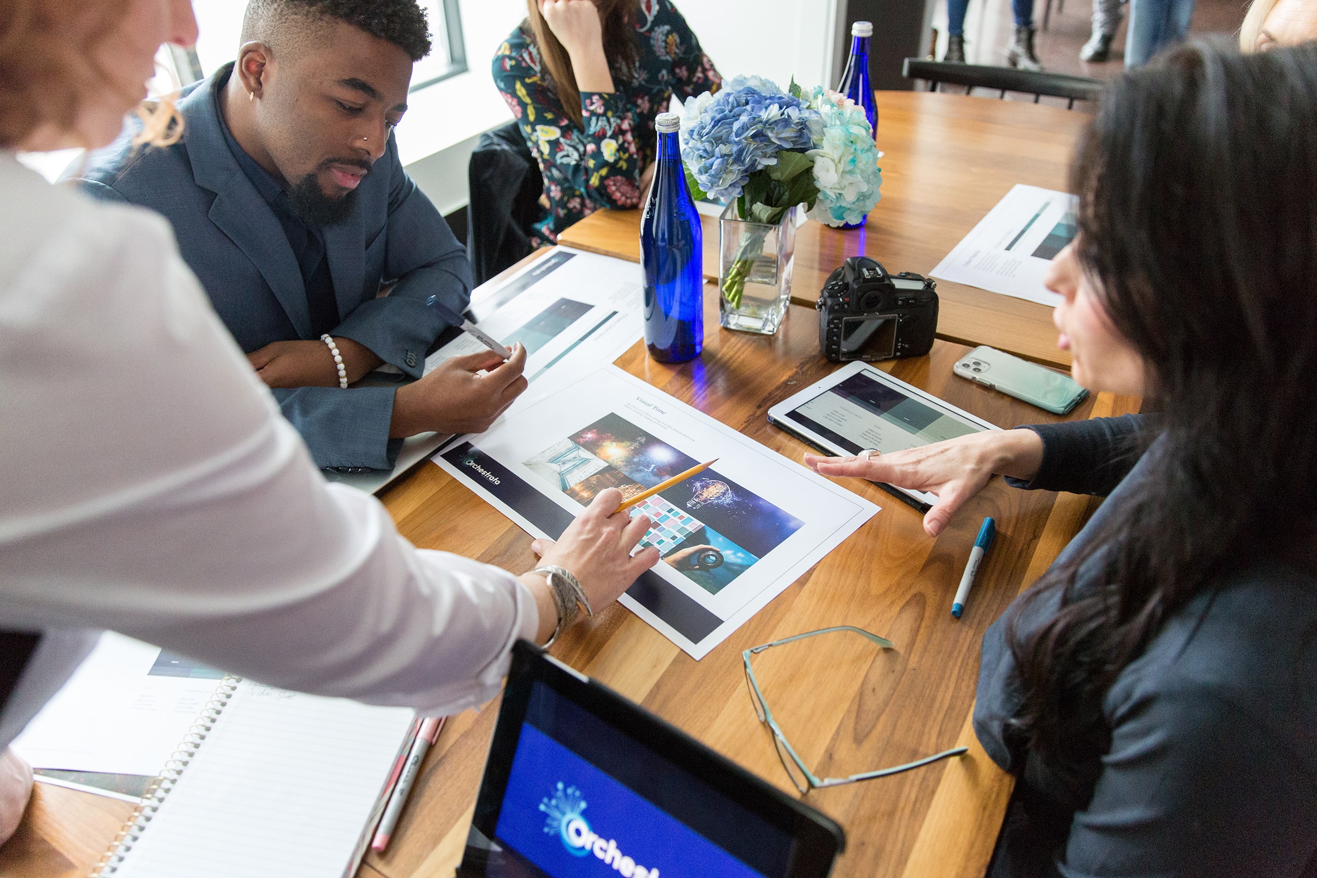 An overhead shot of a woman leading a diverse cast through a branding workshop