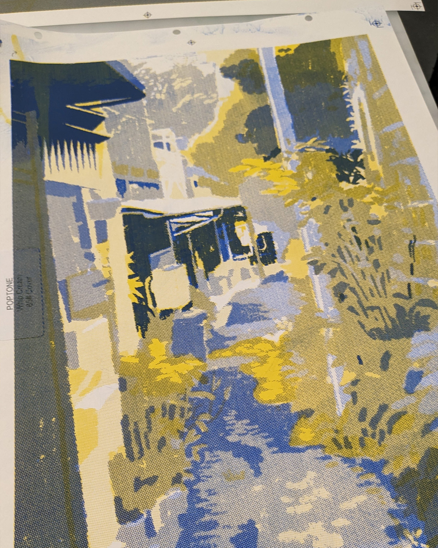 Printed image depicting a blue and yellow stylized alley scene with trees and structures.
