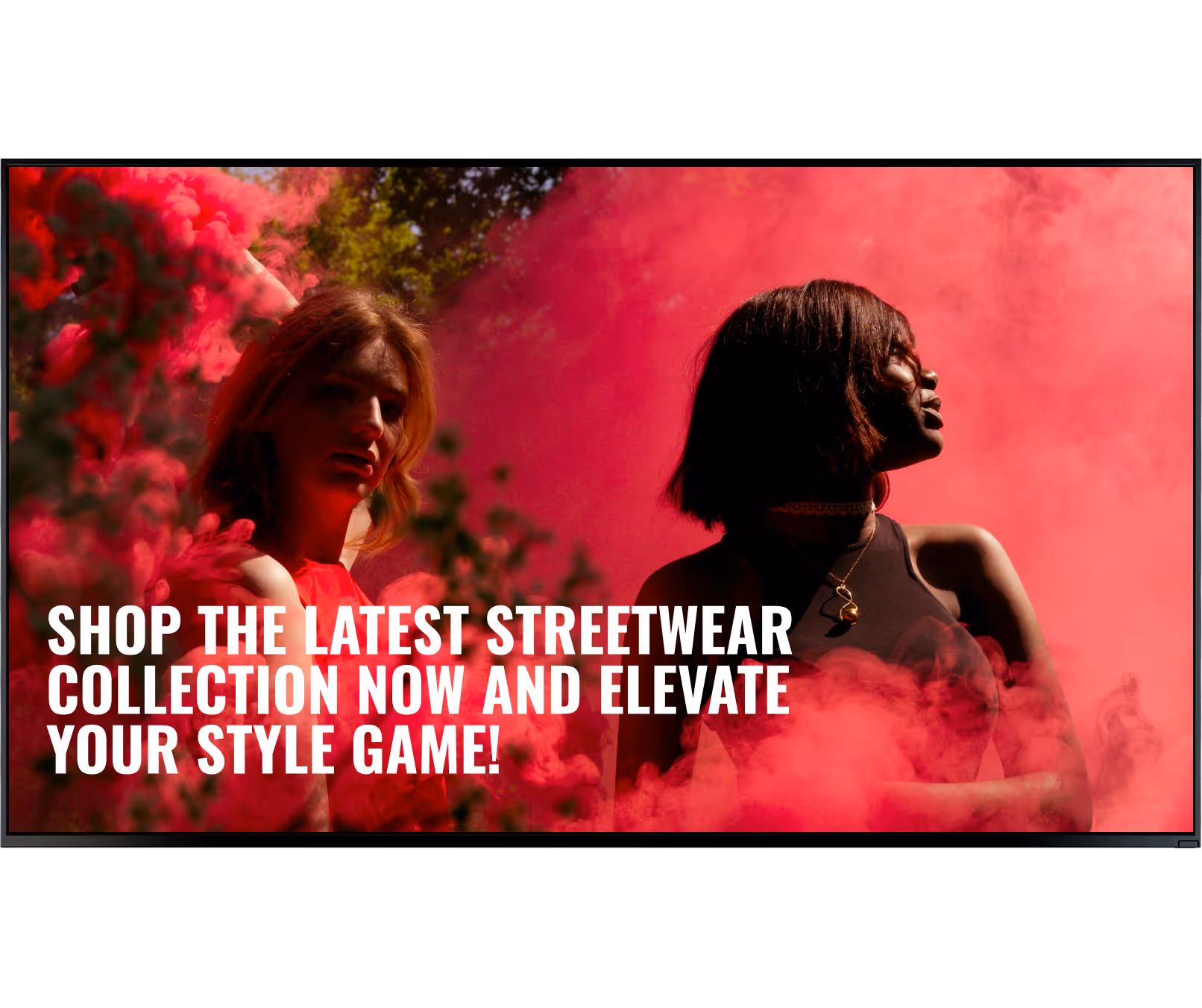 Two women surrounded by vibrant pink smoke with text promoting the latest streetwear collection.