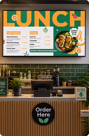 Lunch menu board showing dishes, drinks, and chicken caesar salad priced at $10 above a cafe counter.