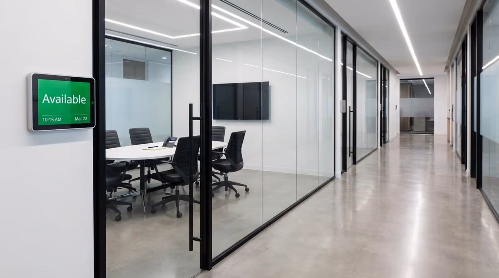 A digital room scheduling panel in a sleek office corridor indicating availability and efficiency.