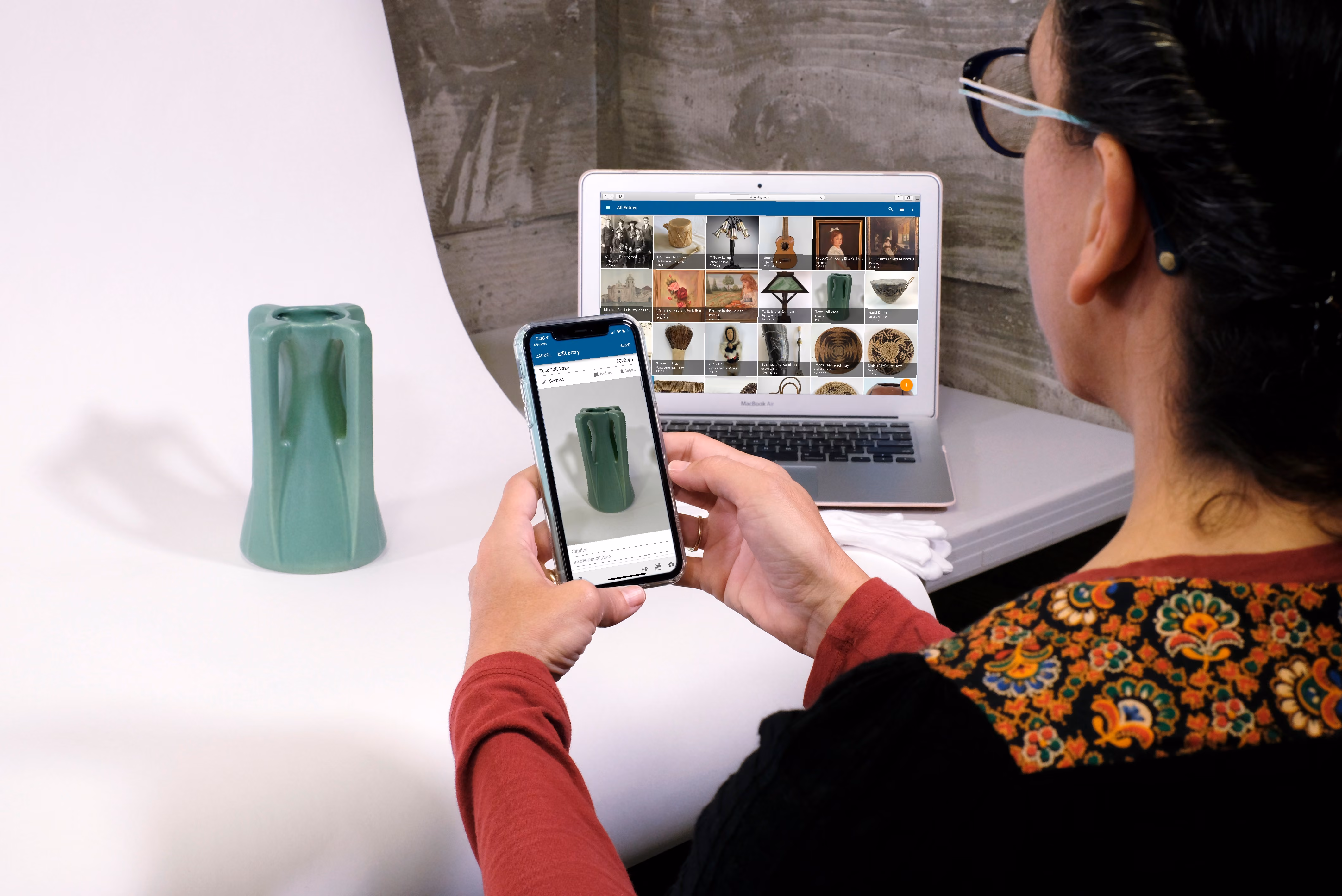 Museum professional cataloging a vase using a mobile device.