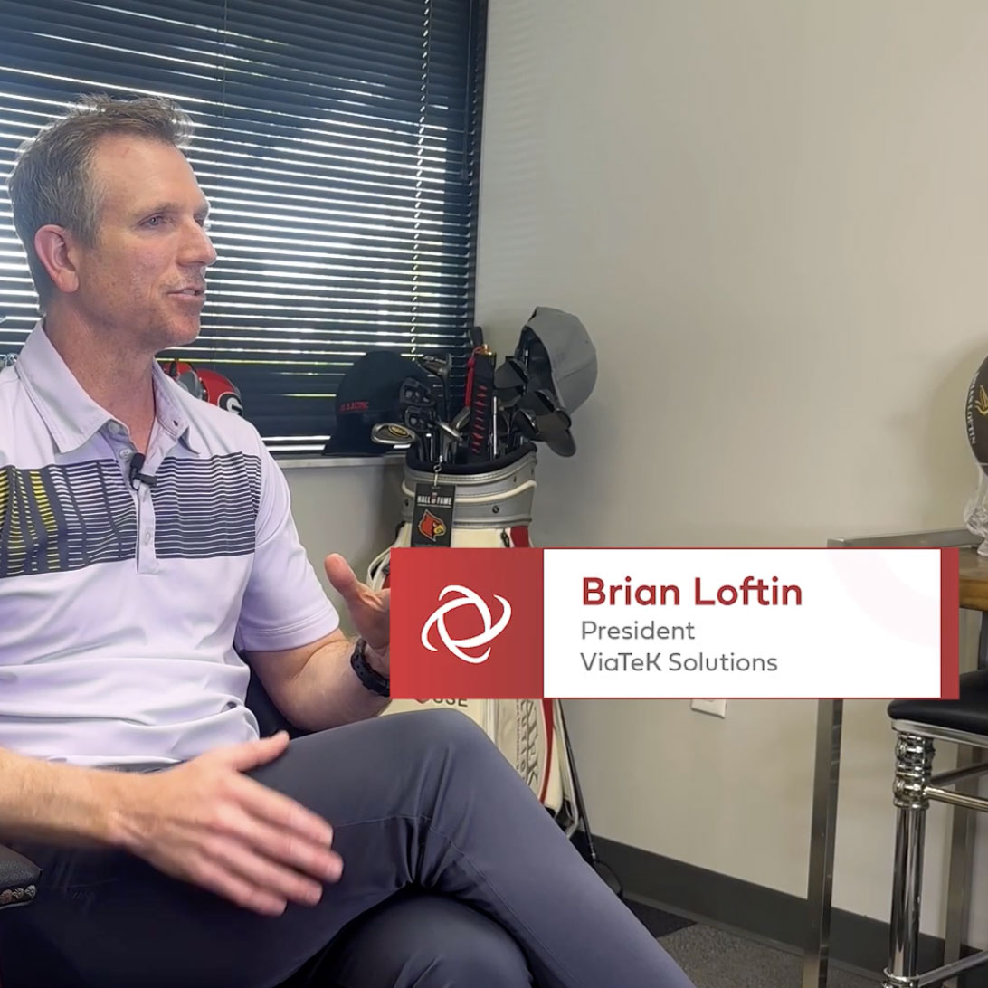 Brian Loftin sitting, speaking in his office.