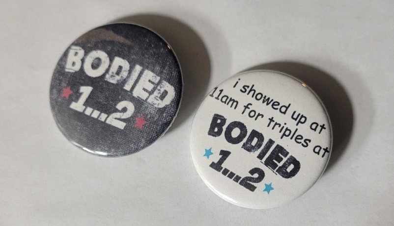 Promotional pin designs created for Bodied 12 tournament merchandise.