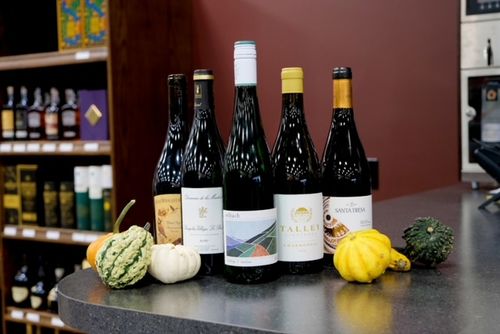 Selection of five wine bottles on a counter