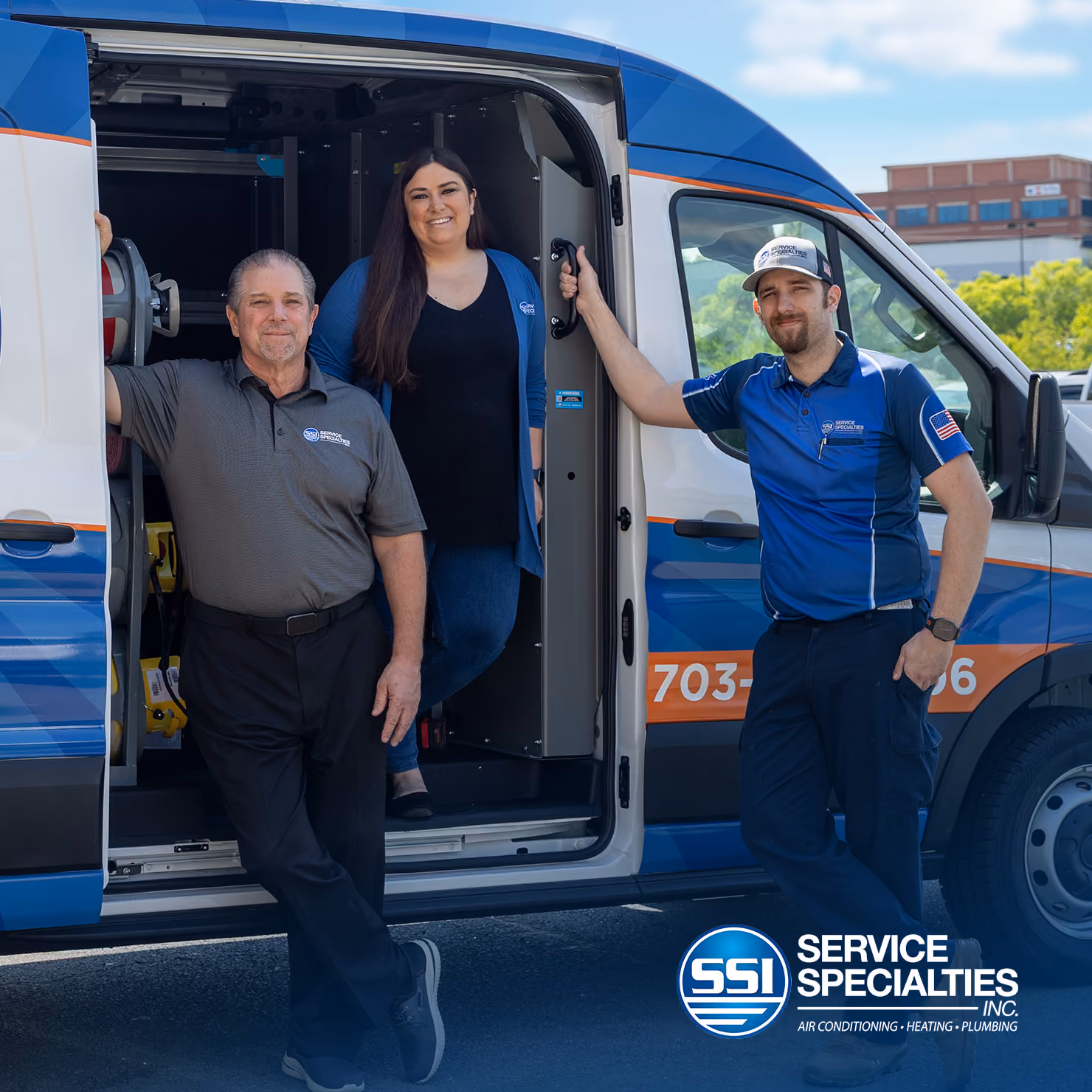 three people standing near hvac van