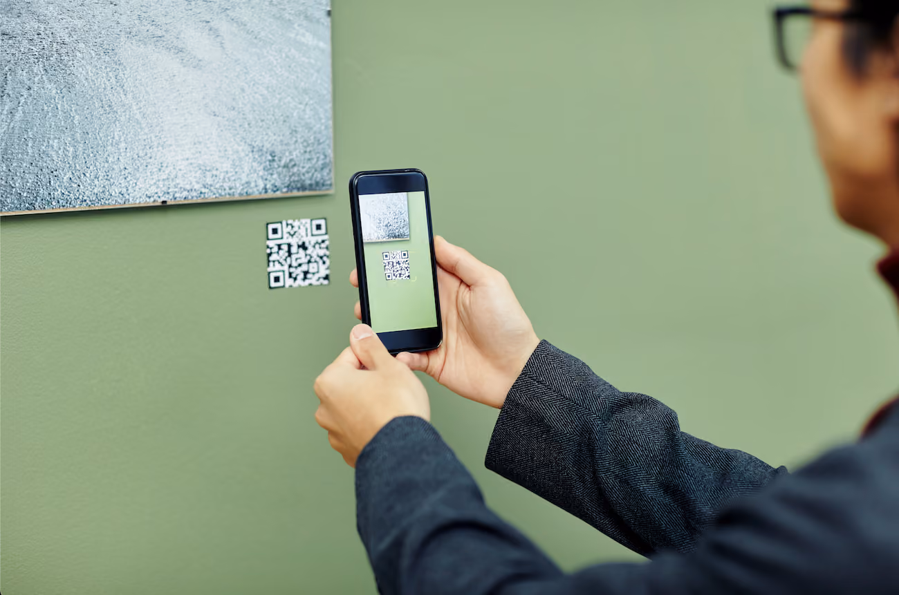 A museum patron scanning an artwork's QR Code with a cell phone. Image courtesy of Shutterstock.