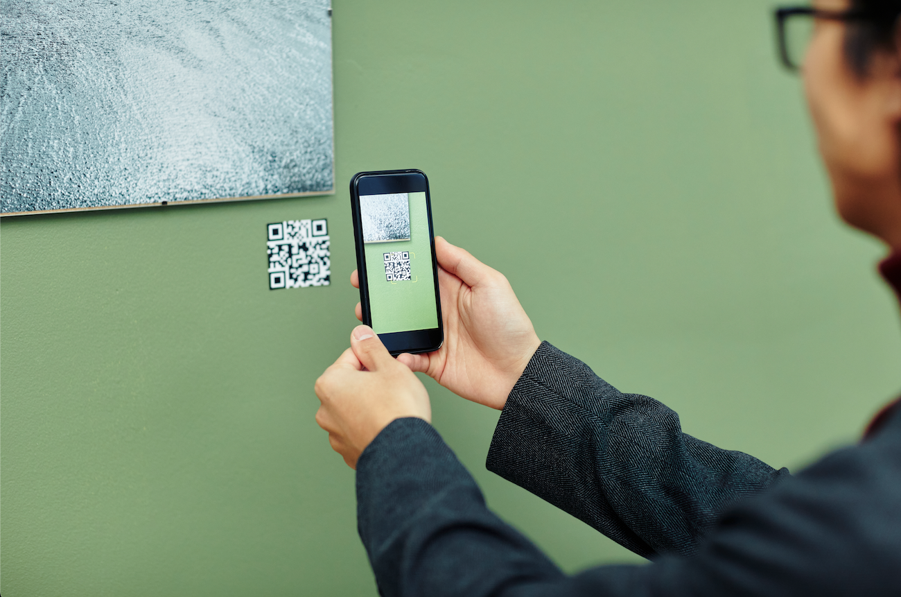 A museum patron scanning an artwork's QR Code with a cell phone. Image courtesy of Shutterstock.
