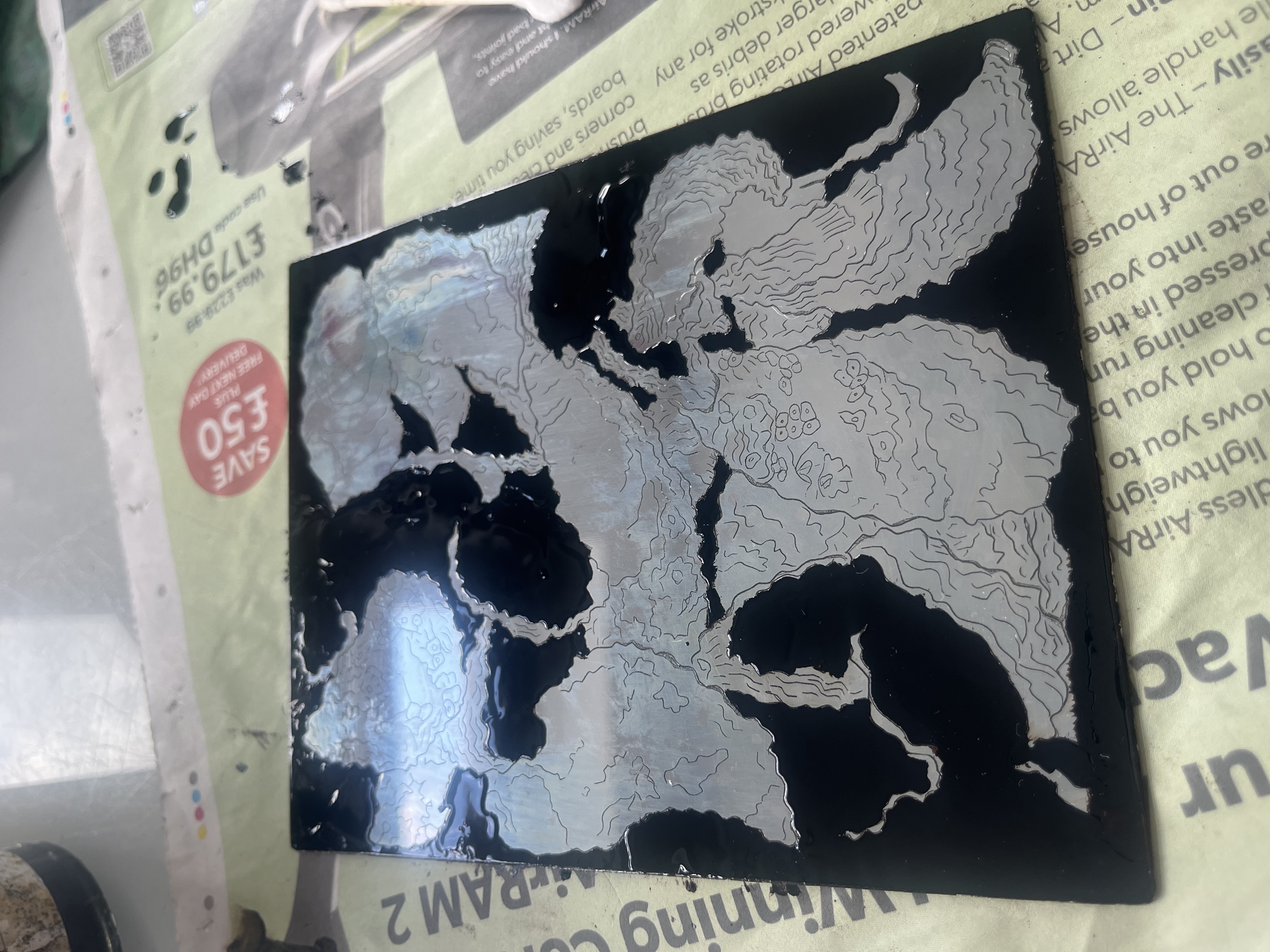 Progress photo where most of the oysters are painted out on the plate, leaving a few to be shaded in using acid. 