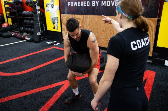 A young girl lifting weight overhead