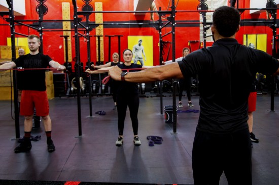 A young girl lifting weight overhead