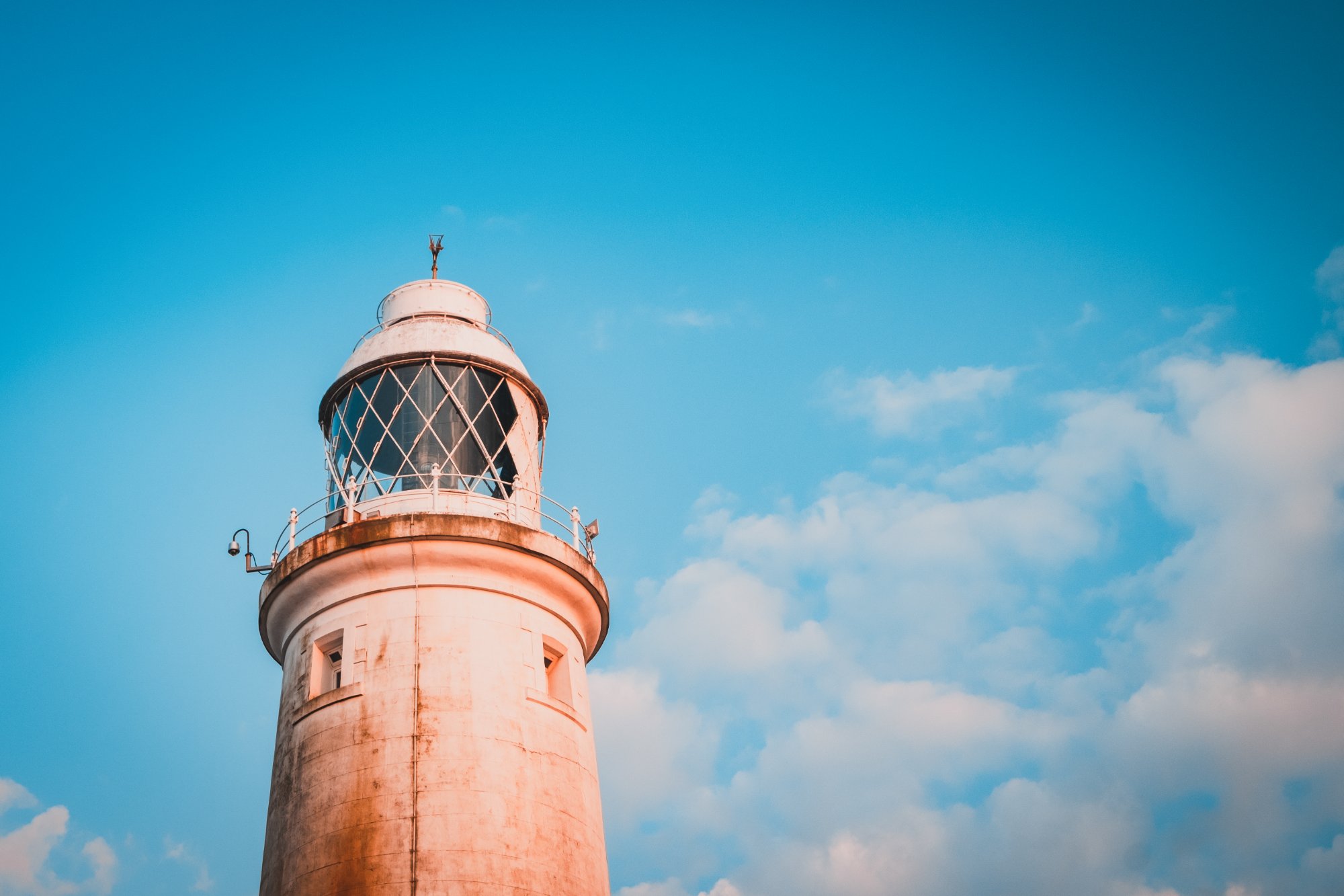 Top of a lighthouse against blue sky
