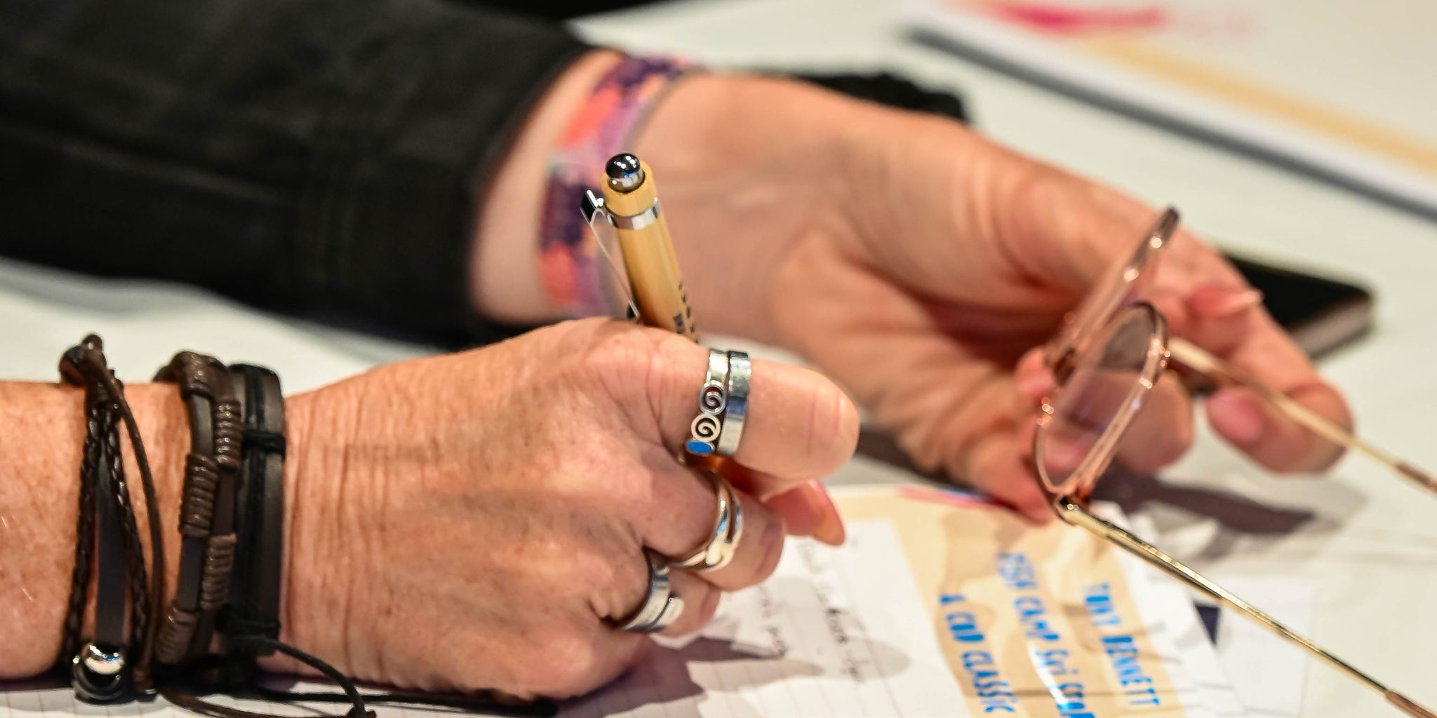 An image of a client hand working on the workbook to determine the leak of the tradie business