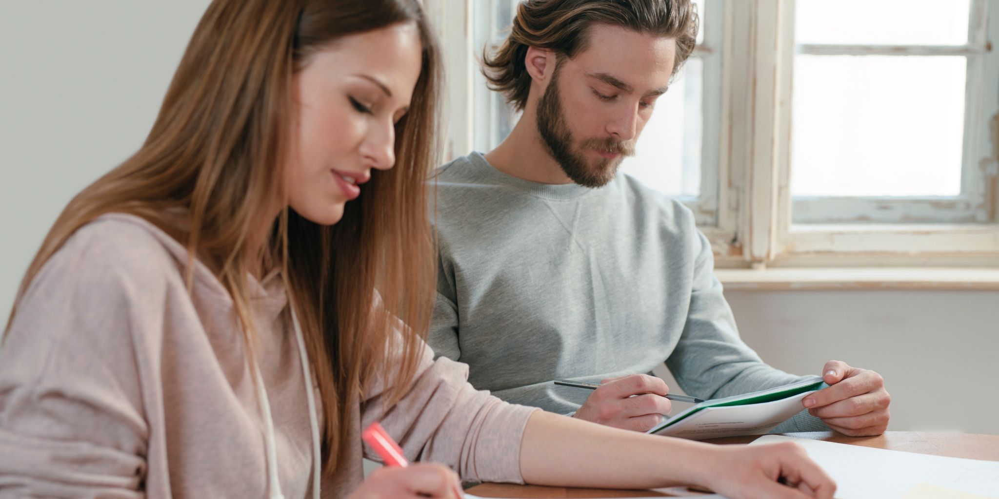 An image of a tradie business couple sitting in a kitchen table reviewing a simple growth plan