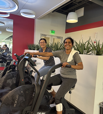 Two Gymparty members working out on exercise bikes