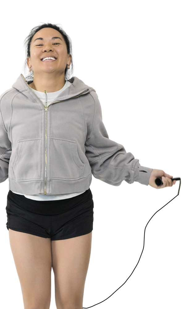 Gymparty member smiling while skipping with a jump rope