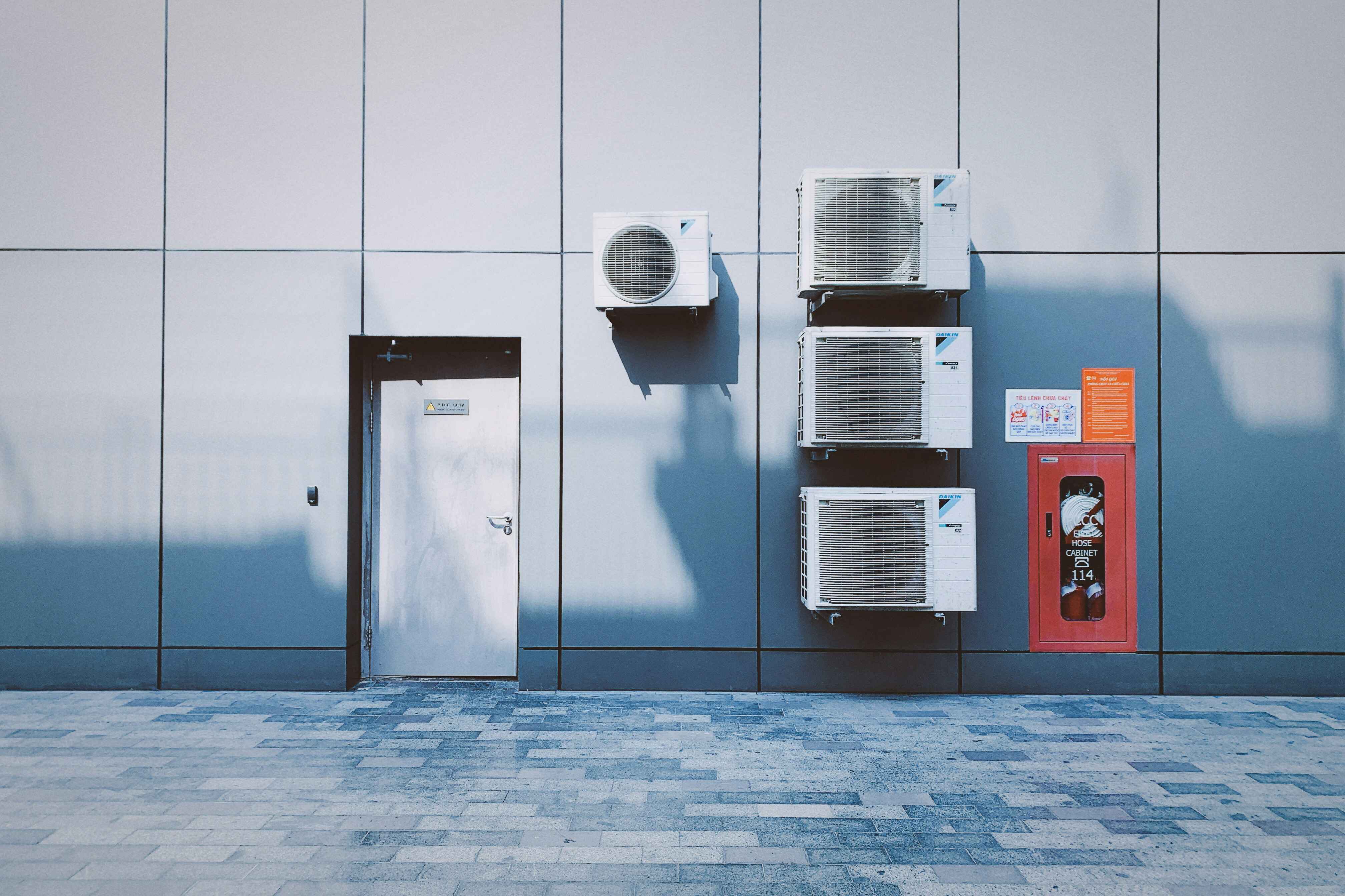 Air conditioning units mounted on a tiled exterior wall