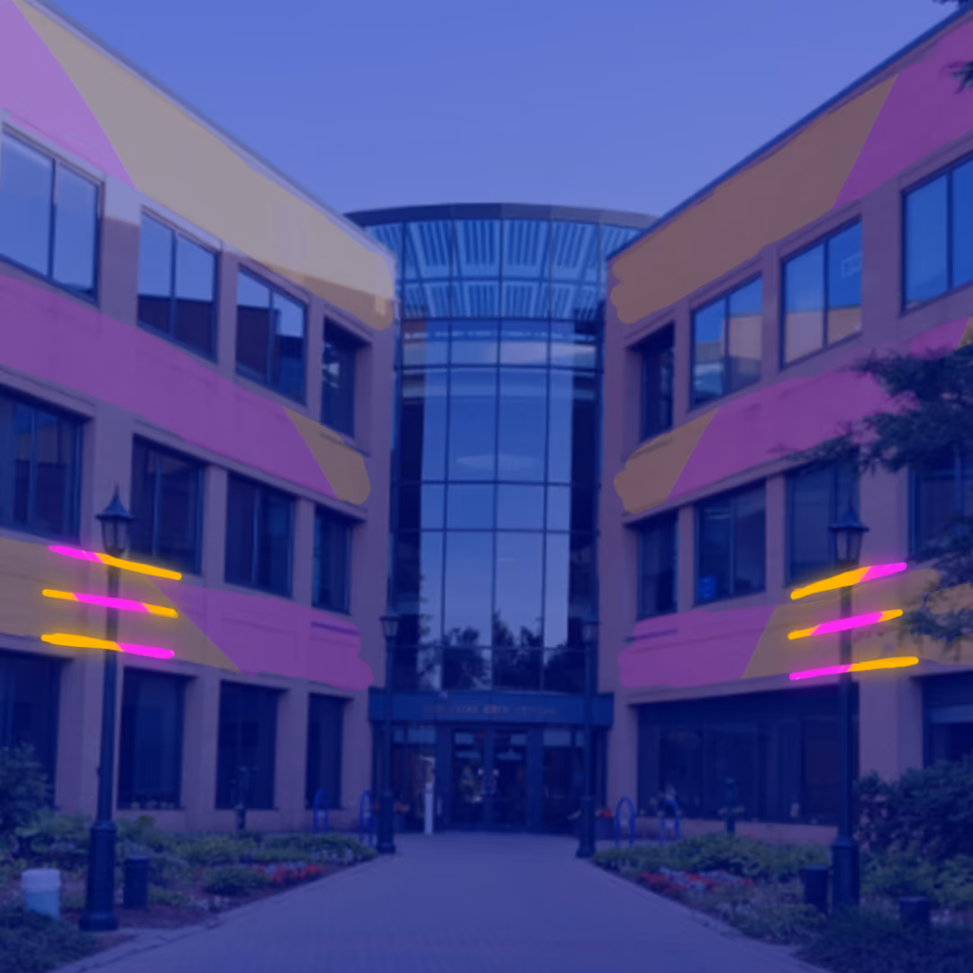 Exterior view of Waterloo City Hall building with symmetrical pink and yellow neon lights framing the windows, set during twilight.