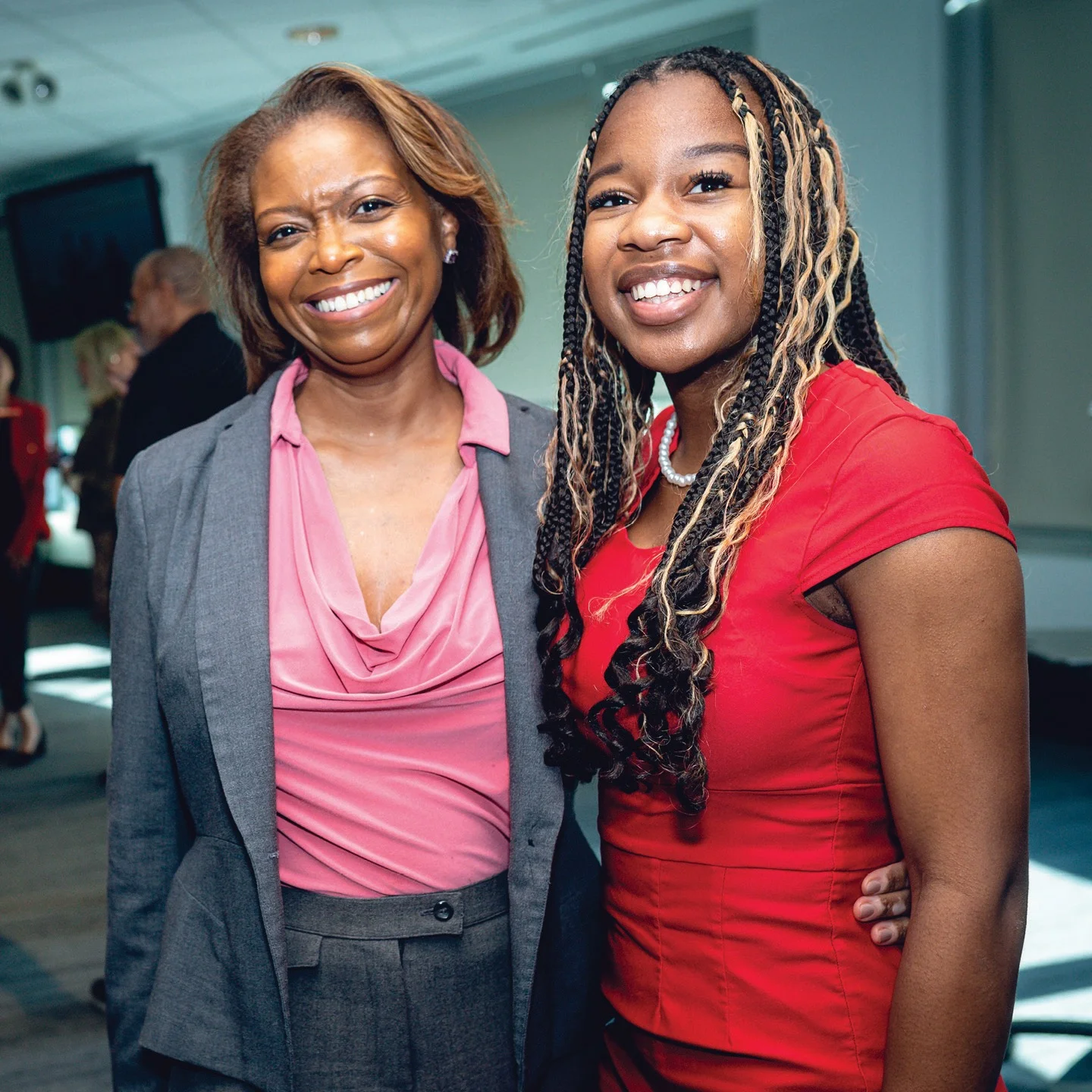 Two women smiling together at a Braven luncheon
