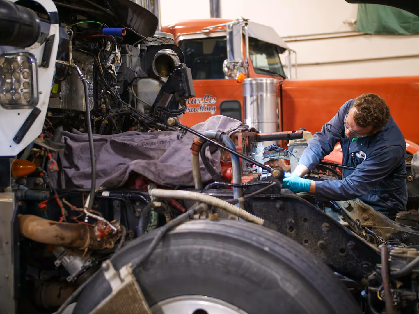 HET diesel mechanic working on a complete engine rebuild for a Cummins ISX.