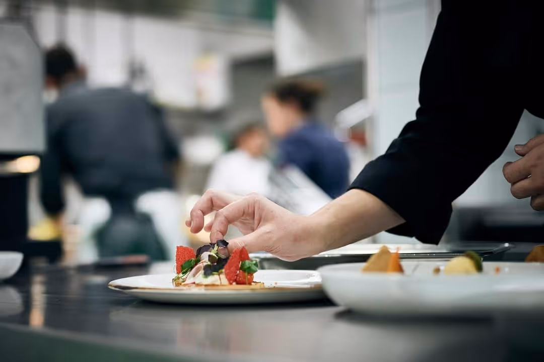 Chef decorates dinner plate