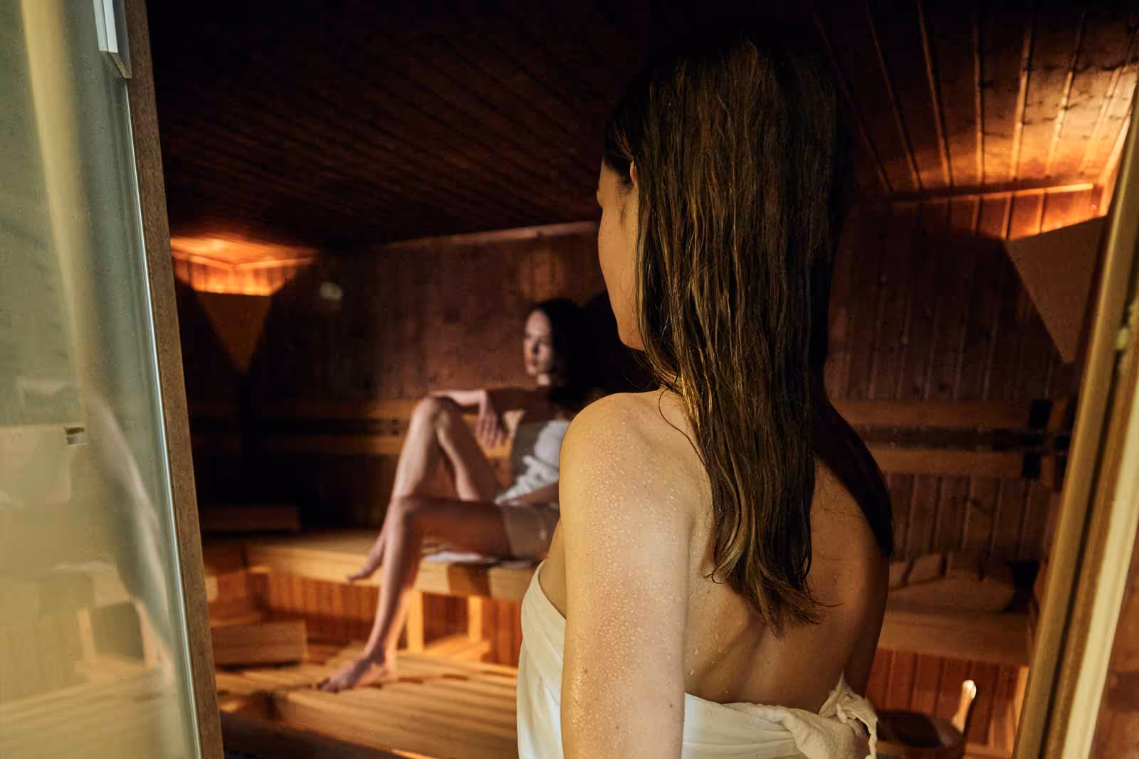 A woman entering the Finnish sauna