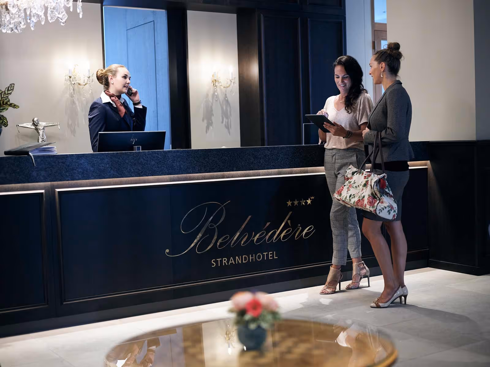 Receptionist welcomes hotel guests