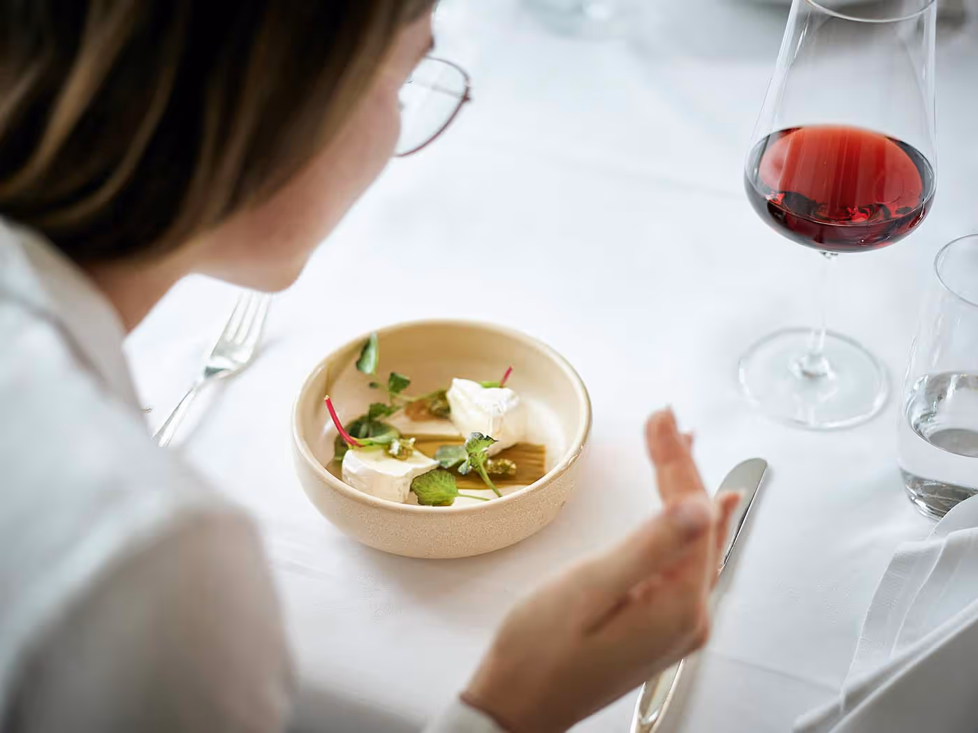 Frau bestaunt an einem Salat mit Frischkäse