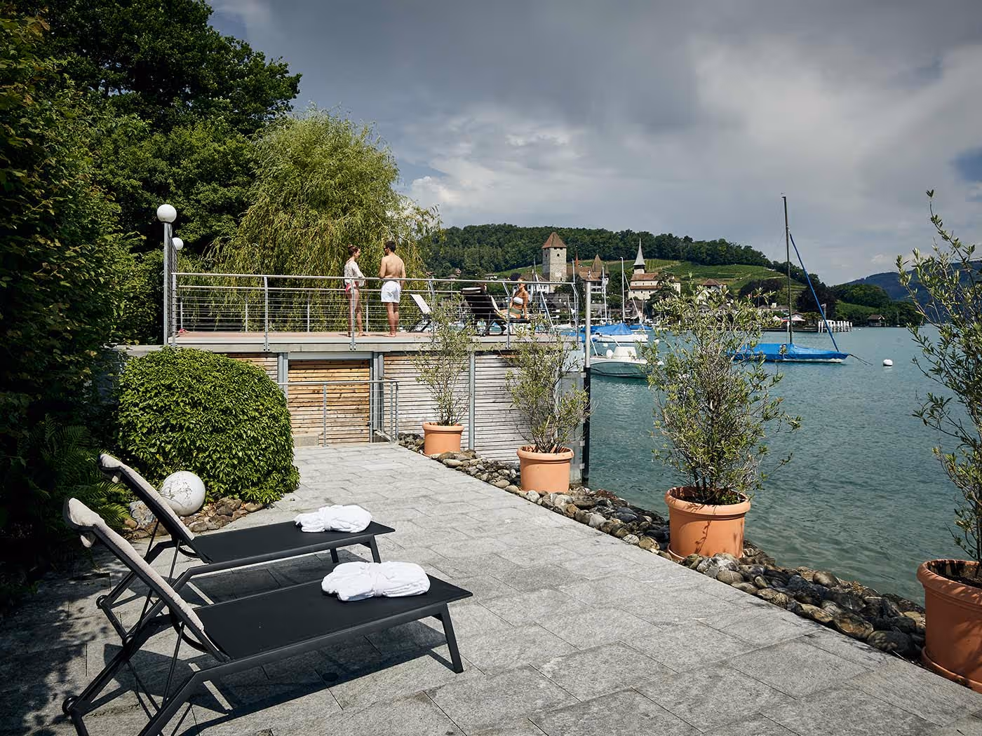 People on the deck of the private lido of the Belédère beach hotel