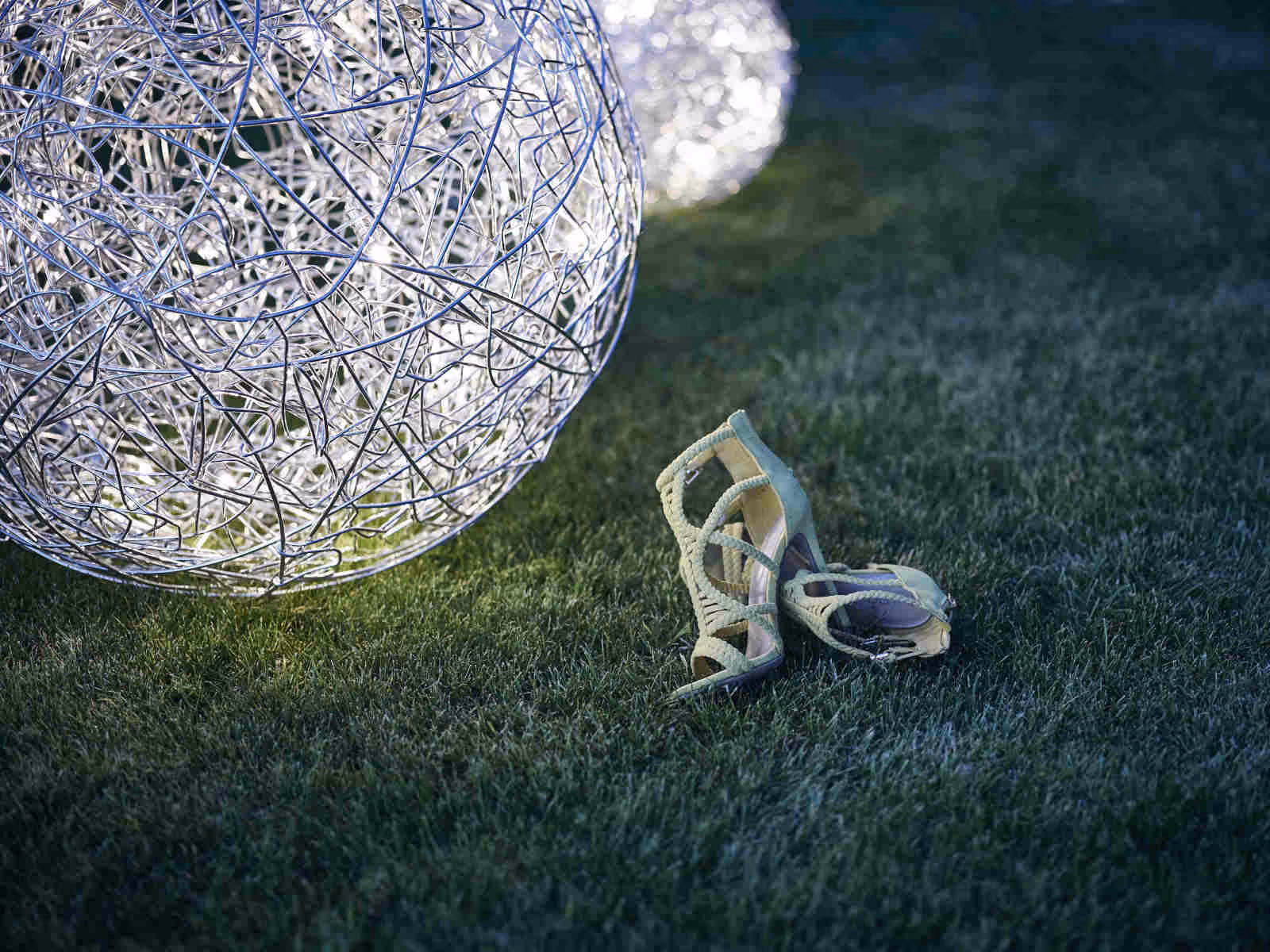 Shoes next to large light ball in the park of the Belvédère Strandhotel