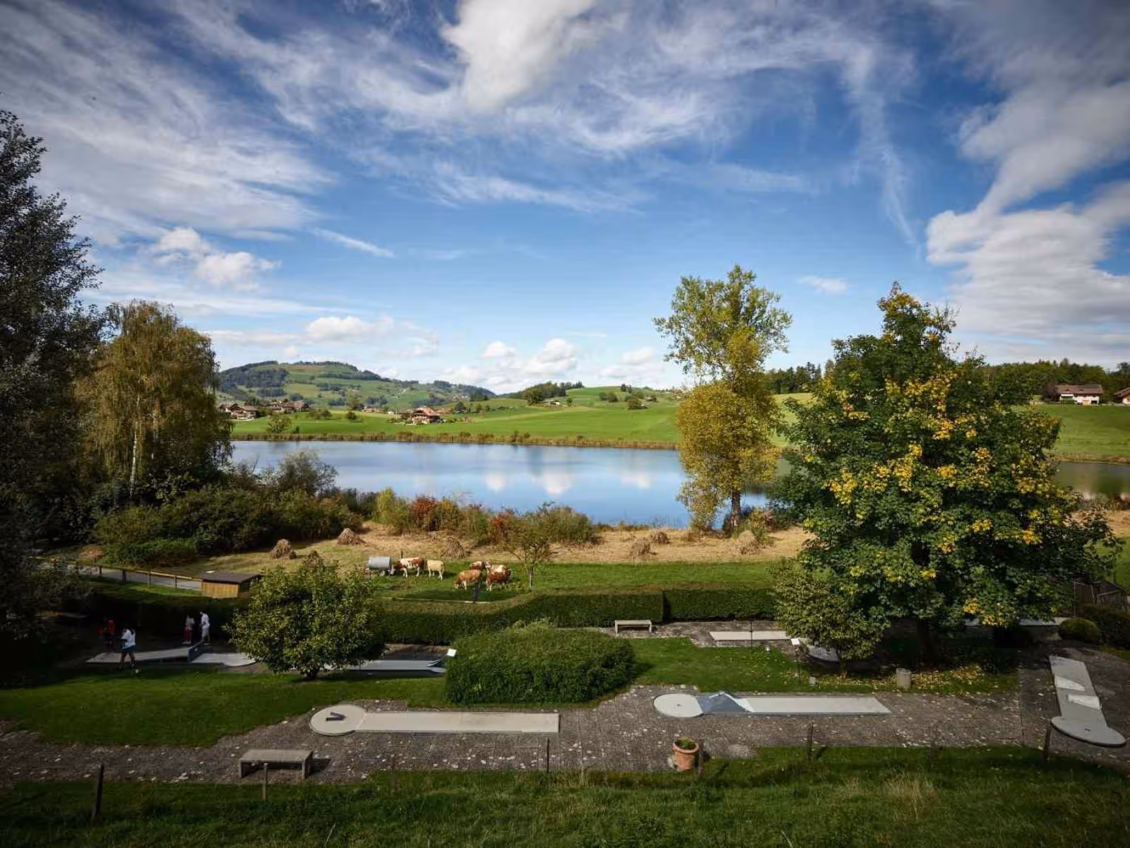 Lake Dittligsee in the Gantrisch Nature Park with a view of the minigolf course of the Grizzly Bear Adventure Land