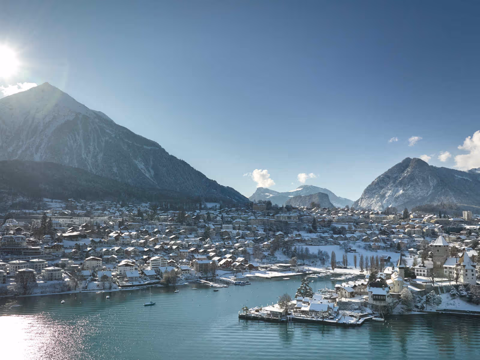 Lake Thun with raft and mountains in the background, snow-covered