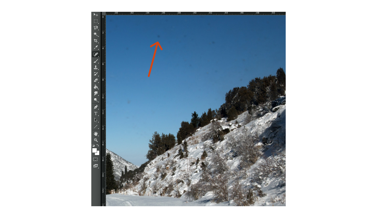 Example of dust marks on a camera sensor as seen against a blue sky