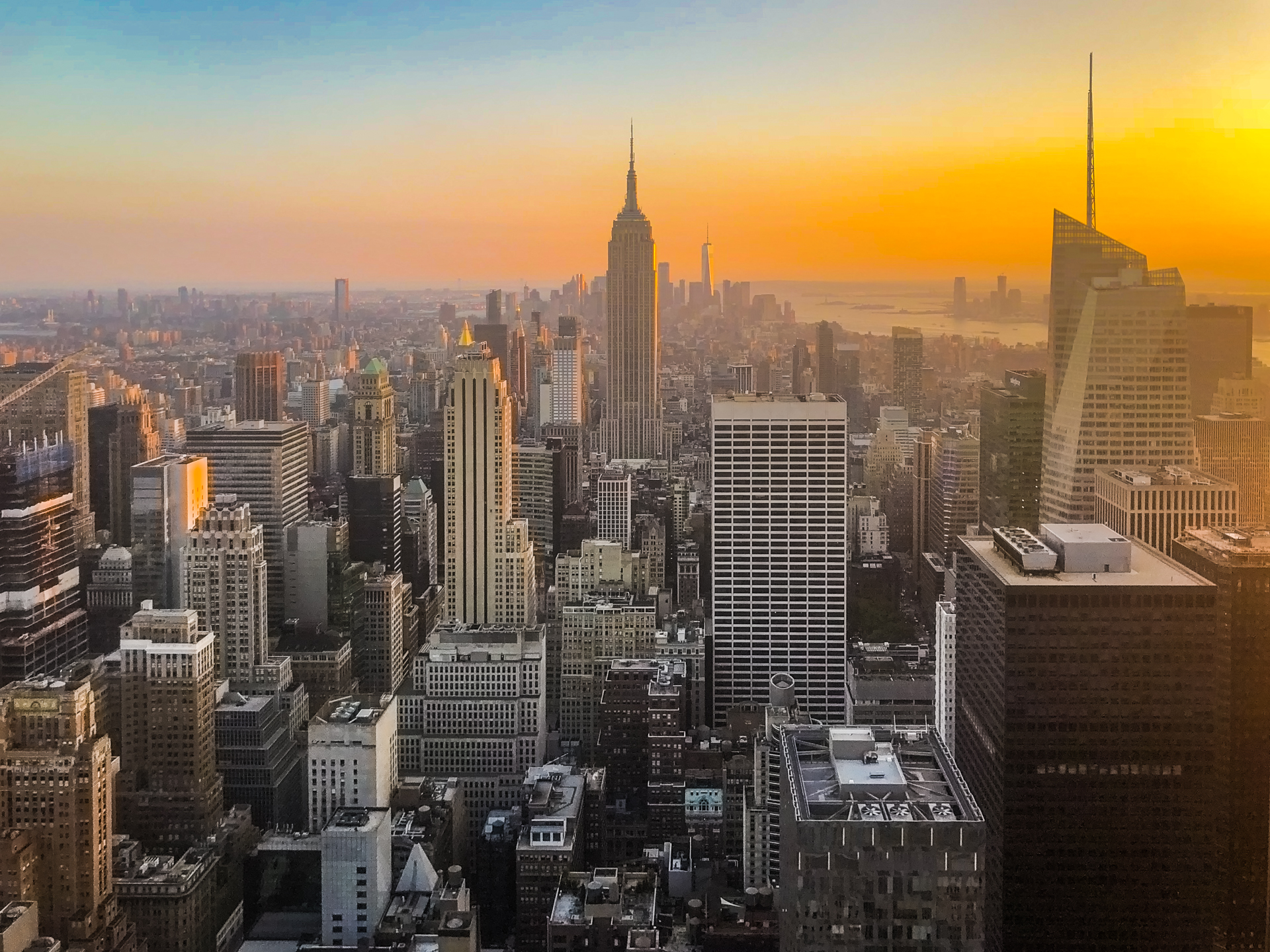 The New York City skyline at sunset with a gradient applied to the bottom of the image to brighten it