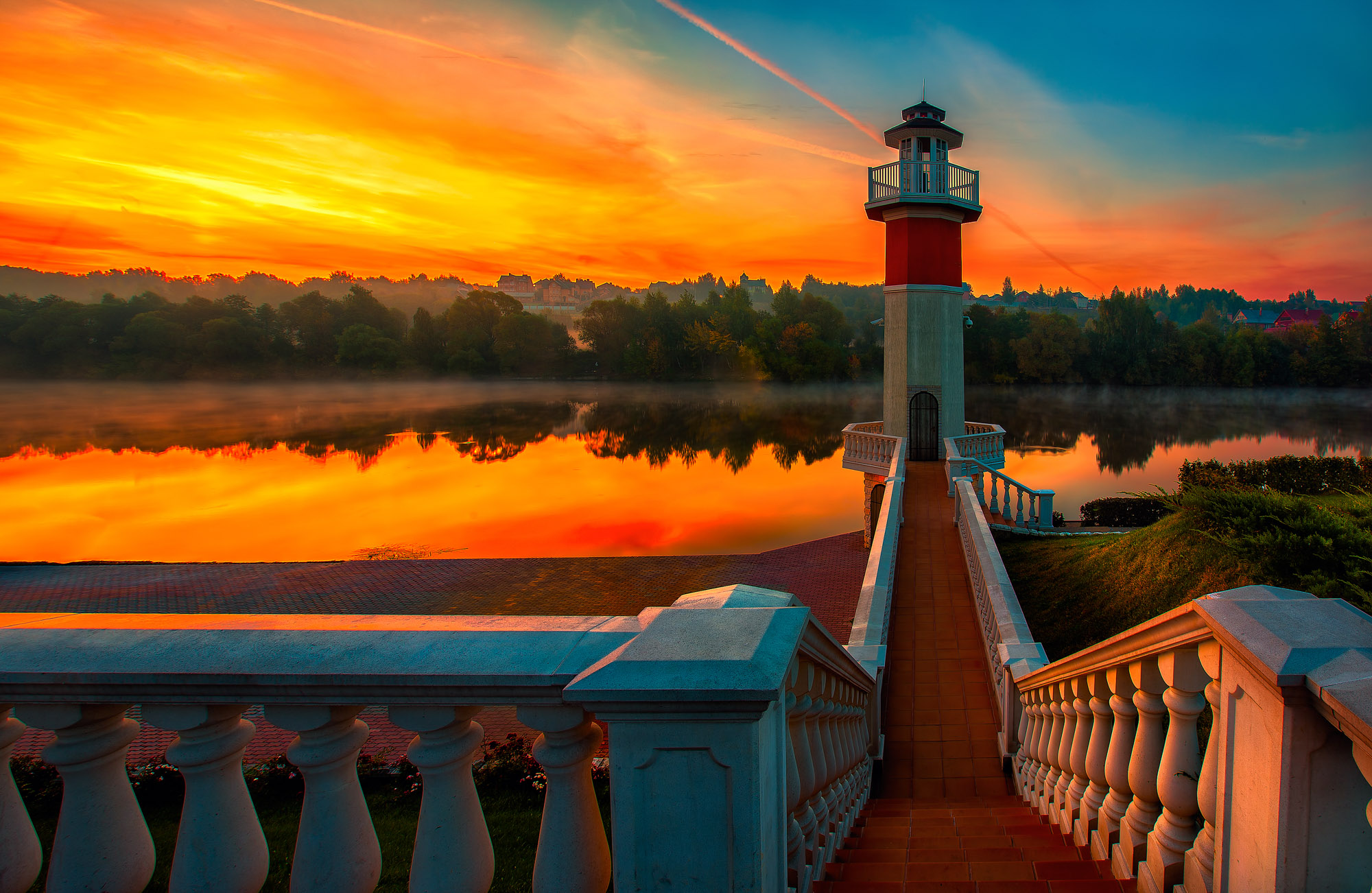 Sunrise at the river with a lighthouse in the foreground